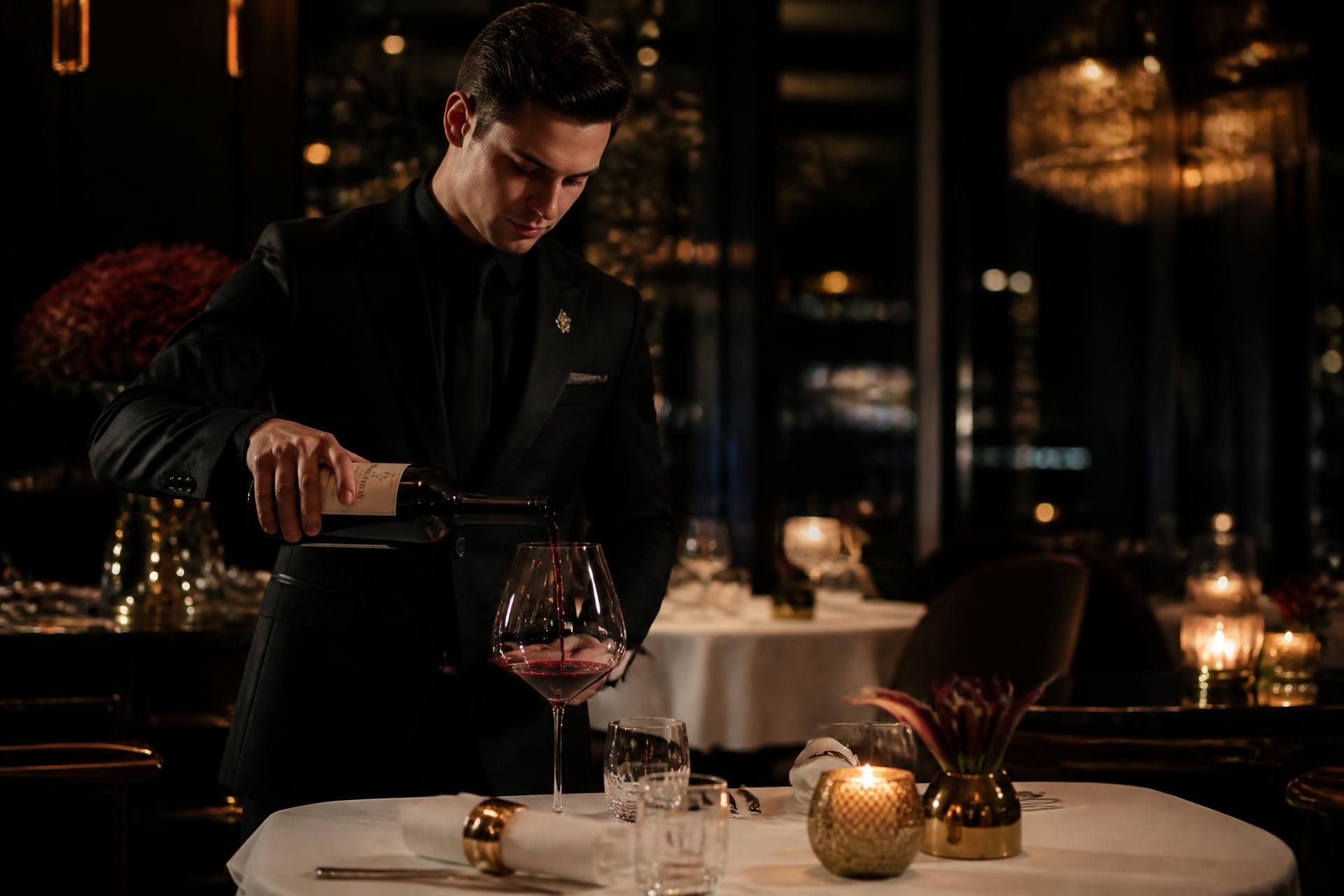 Sommelier pouring wine in a luxury restaurant